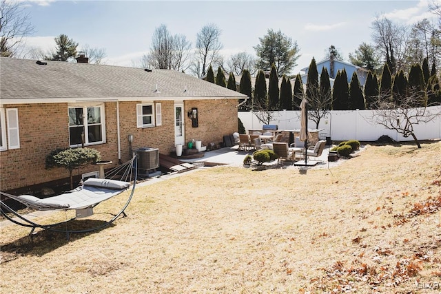 view of yard with a patio area, central AC, and fence