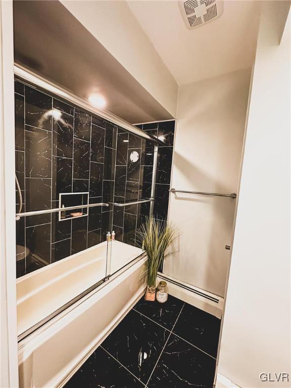 full bath with a baseboard heating unit, tile patterned floors, visible vents, and enclosed tub / shower combo