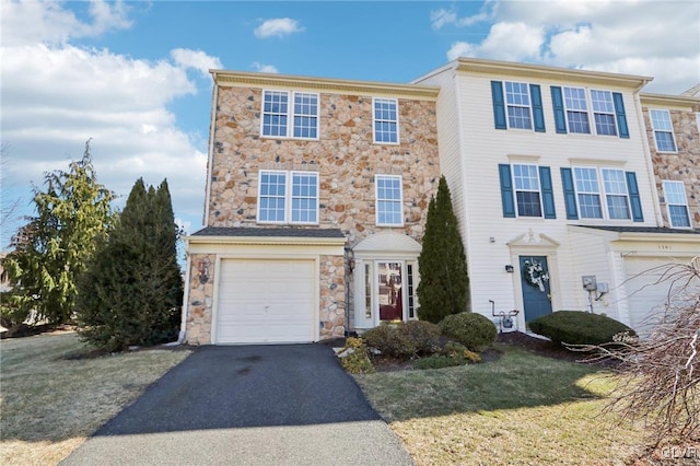 multi unit property featuring driveway, a front lawn, and a garage