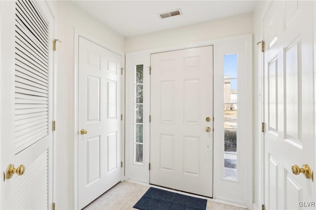 foyer entrance with visible vents