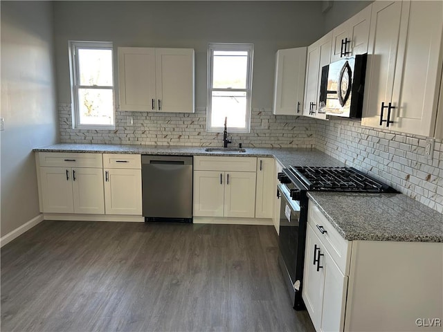 kitchen with black microwave, dishwasher, gas stove, white cabinetry, and a sink