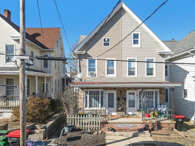 rear view of house featuring a porch