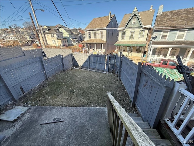 view of yard featuring a residential view and a fenced backyard