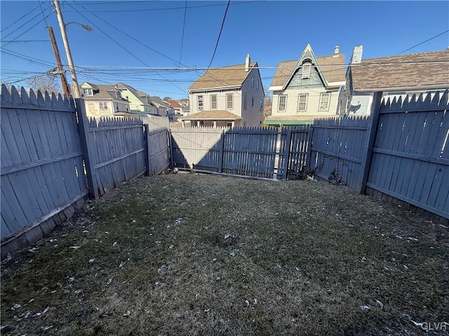 view of yard with a residential view and a fenced backyard