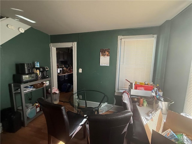 dining room featuring baseboards and wood finished floors