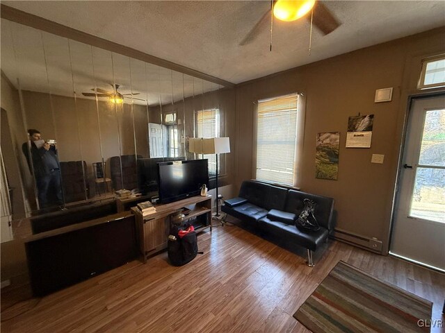 25 S Locust St, Easton, PA 18042 - living room featuring a baseboard heating unit, a textured ceiling, wood finished floors, and ceiling fan