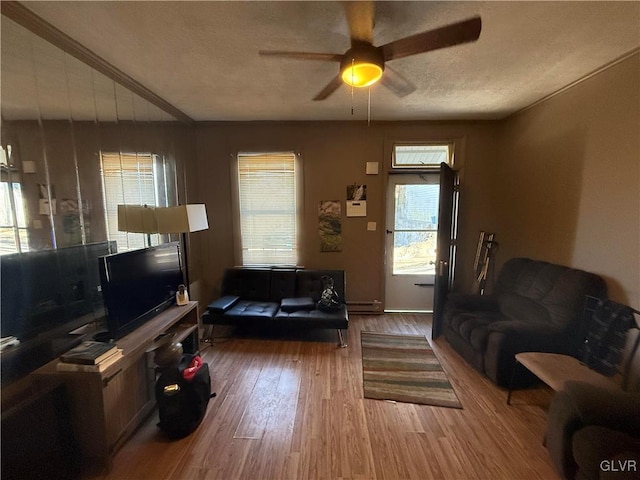 25 S Locust St, Easton, PA 18042 - living area featuring baseboard heating, a textured ceiling, a ceiling fan, and wood finished floors