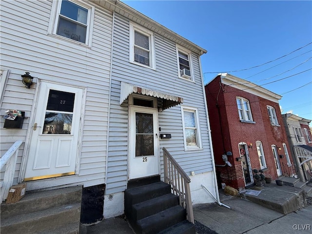 view of front of home with cooling unit and entry steps