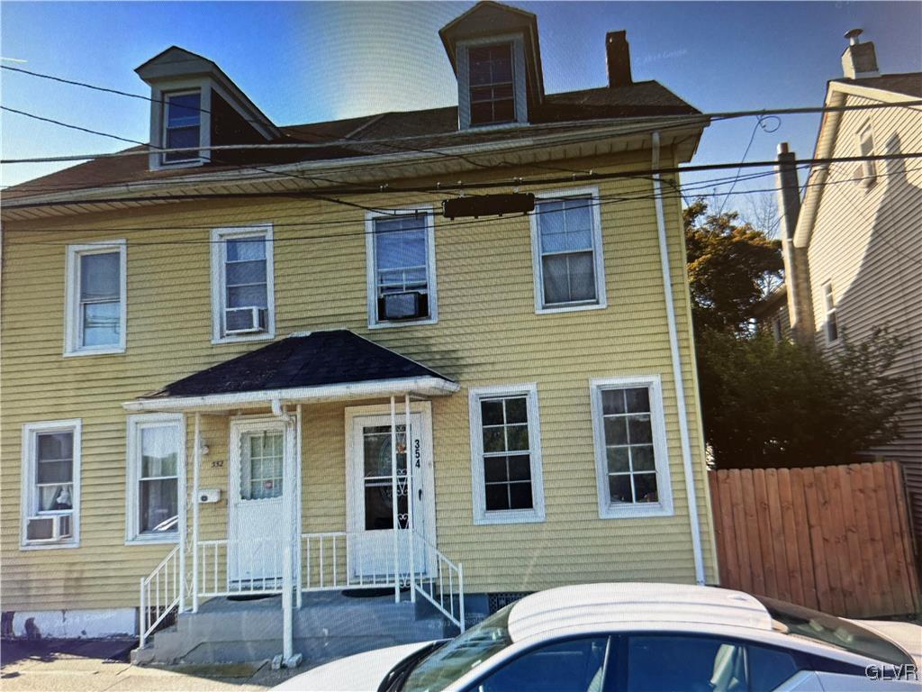 view of front of home featuring fence