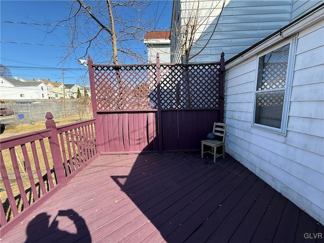 wooden terrace with a residential view and fence