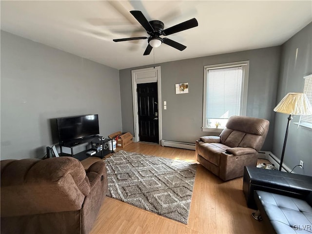 living area with ceiling fan, wood finished floors, and a baseboard radiator