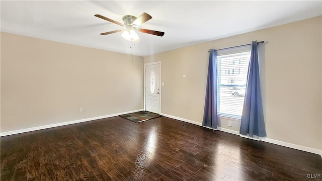 unfurnished room featuring baseboards, wood finished floors, and a ceiling fan