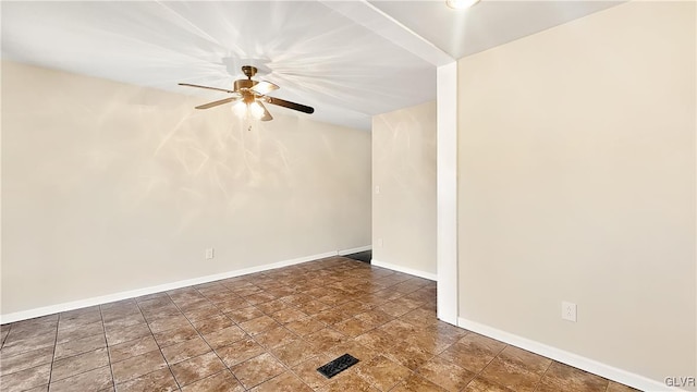 spare room with baseboards and ceiling fan