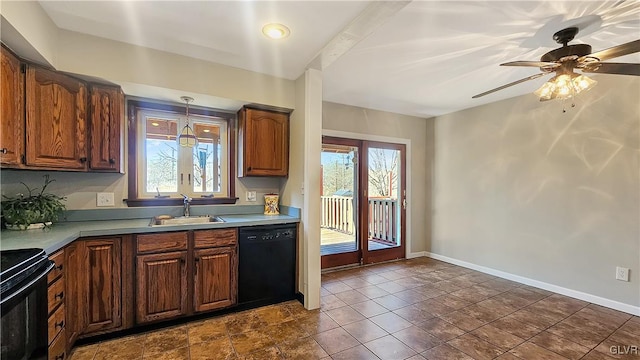 kitchen featuring a sink, baseboards, black appliances, and a wealth of natural light