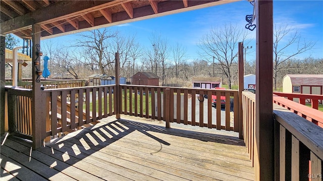 wooden deck with a shed and an outdoor structure