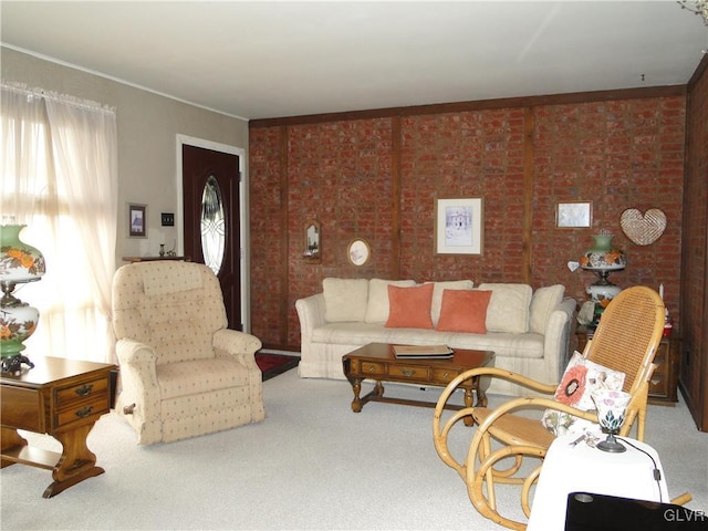 living area featuring carpet flooring and brick wall