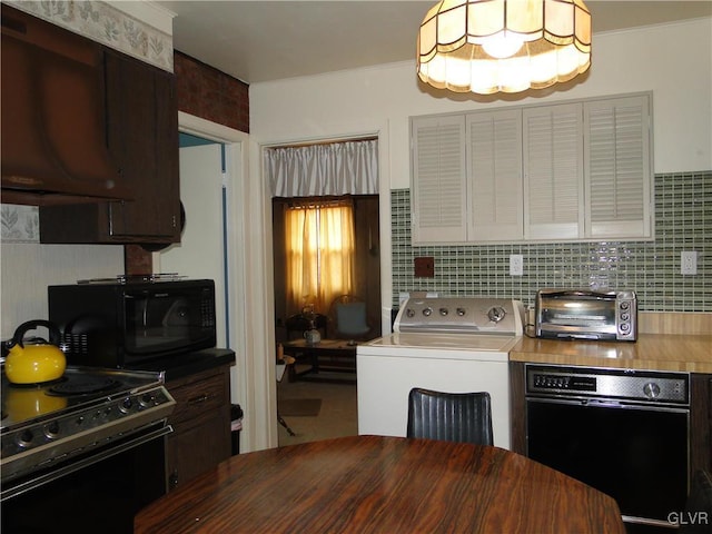 kitchen featuring a toaster, washer / dryer, black appliances, and decorative backsplash