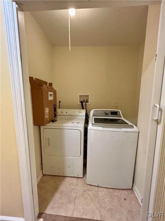 laundry area featuring laundry area, baseboards, and washer and clothes dryer