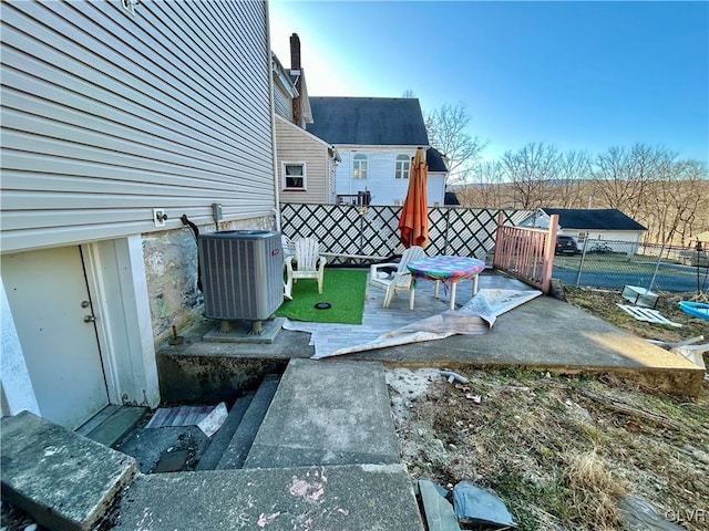 exterior space featuring cooling unit, a deck, and fence