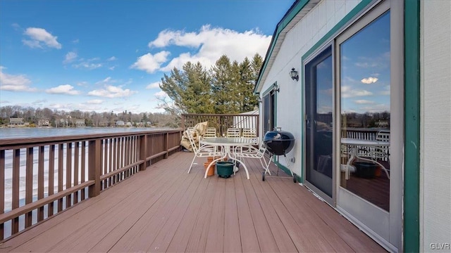 wooden terrace with a water view and a grill