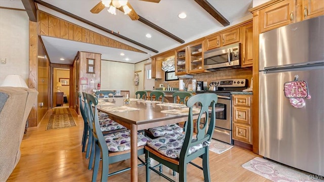 dining space with lofted ceiling with beams, recessed lighting, light wood-type flooring, and ceiling fan