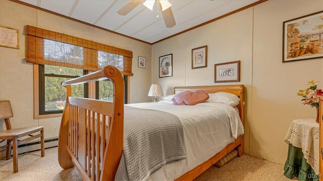 carpeted bedroom featuring a baseboard radiator, ornamental molding, and a ceiling fan