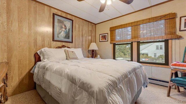 bedroom featuring wooden walls, carpet flooring, a baseboard radiator, and ornamental molding