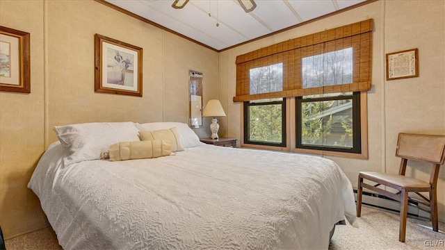 bedroom with ceiling fan, a baseboard heating unit, ornamental molding, and carpet flooring