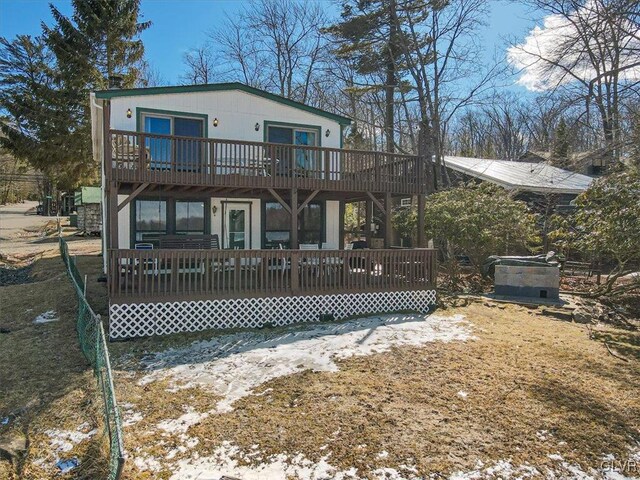 rear view of house featuring a deck