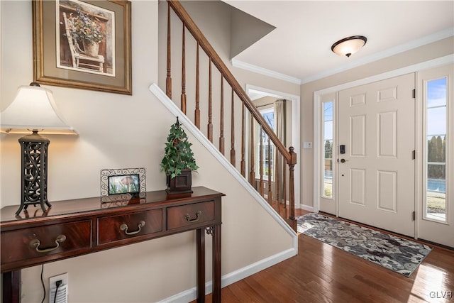 entryway with stairs, baseboards, wood finished floors, and crown molding