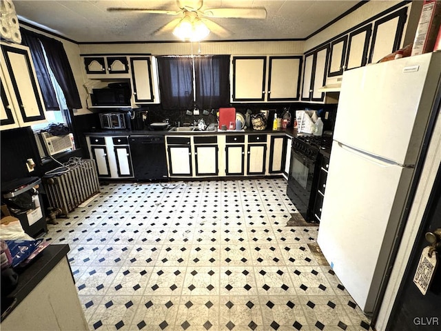 kitchen with black appliances, dark countertops, under cabinet range hood, and ornamental molding