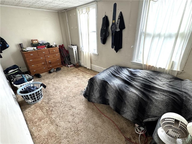 bedroom featuring radiator heating unit, carpet, and ornamental molding