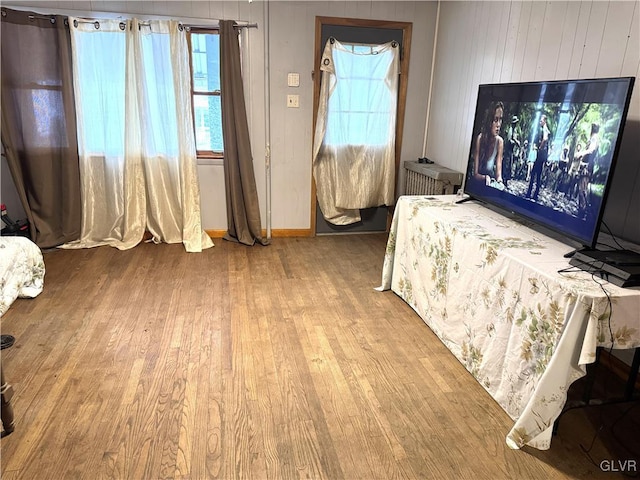 bedroom with baseboards and wood finished floors