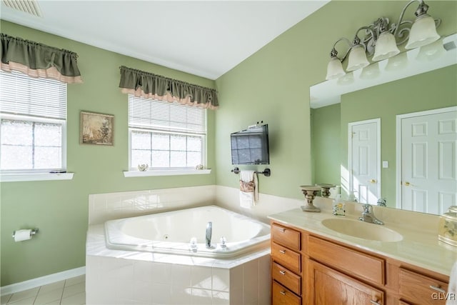 full bath with tile patterned floors, vanity, plenty of natural light, and a jetted tub