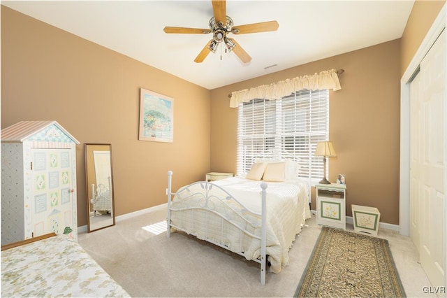 carpeted bedroom featuring baseboards, ceiling fan, and a closet