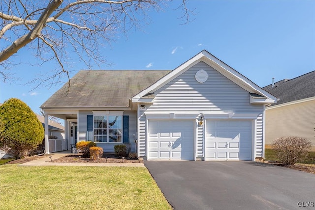 ranch-style home with aphalt driveway, a garage, and a front lawn