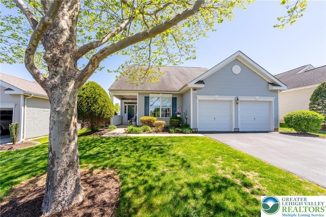 single story home with a garage, driveway, and a front yard