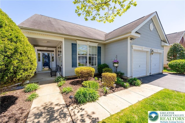 view of front of home with a garage and aphalt driveway