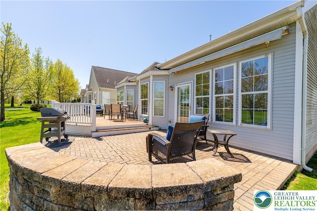 view of patio featuring a deck, outdoor dining space, and area for grilling