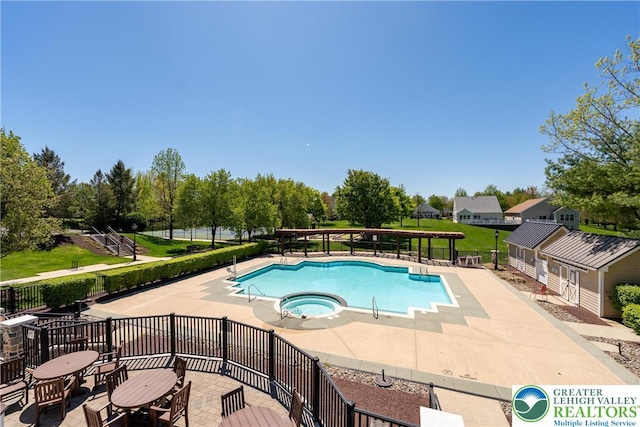 pool with a patio and a community hot tub