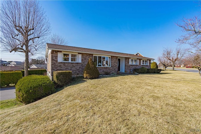 ranch-style house with brick siding and a front lawn