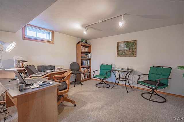 office space featuring rail lighting, carpet, and baseboards