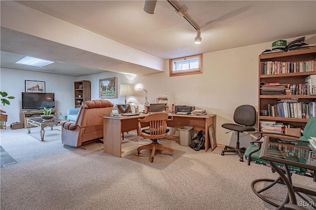 carpeted home office with rail lighting