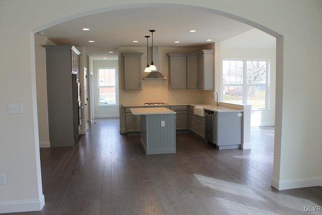 kitchen featuring stainless steel dishwasher, dark wood-style floors, a kitchen island, and gray cabinetry