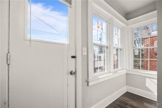 doorway to outside with baseboards, dark wood-type flooring, and a healthy amount of sunlight