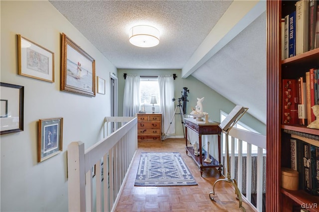 corridor with a textured ceiling and lofted ceiling with beams