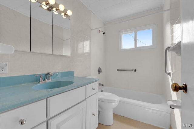 full bathroom featuring toilet, ornamental molding, tile walls, tub / shower combination, and vanity