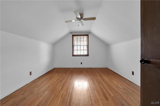 bonus room with baseboards, lofted ceiling, ceiling fan, and hardwood / wood-style flooring