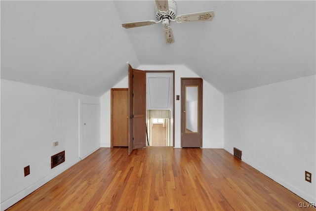 bonus room featuring a ceiling fan, baseboards, visible vents, lofted ceiling, and light wood-style flooring