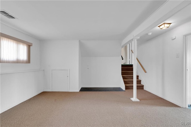 below grade area featuring visible vents, carpet floors, and stairs